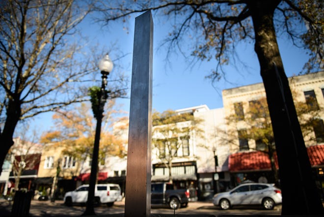 A mini monolith stands in a raised flowerbed on Hay Street on Tuesday. The 3-foot-tall sculpture first appeared Dec. 3, and nobody as yet has taken credit for placing it there.
