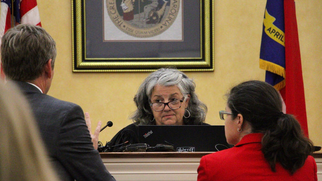 Superior Court Judge Sherri Murrell, center, speaks with Orange County District Attorney Jeff Nieman and public defender Dana Graves, Tuesday, Aug. 29, 2023, in Hillsborough, N.C, during the first court appearance of Tailei Qi. Qi is accused of fatally shooting his faculty adviser at UNC-Chapel Hill. (AP Photo/Hannah Schoenbaum)